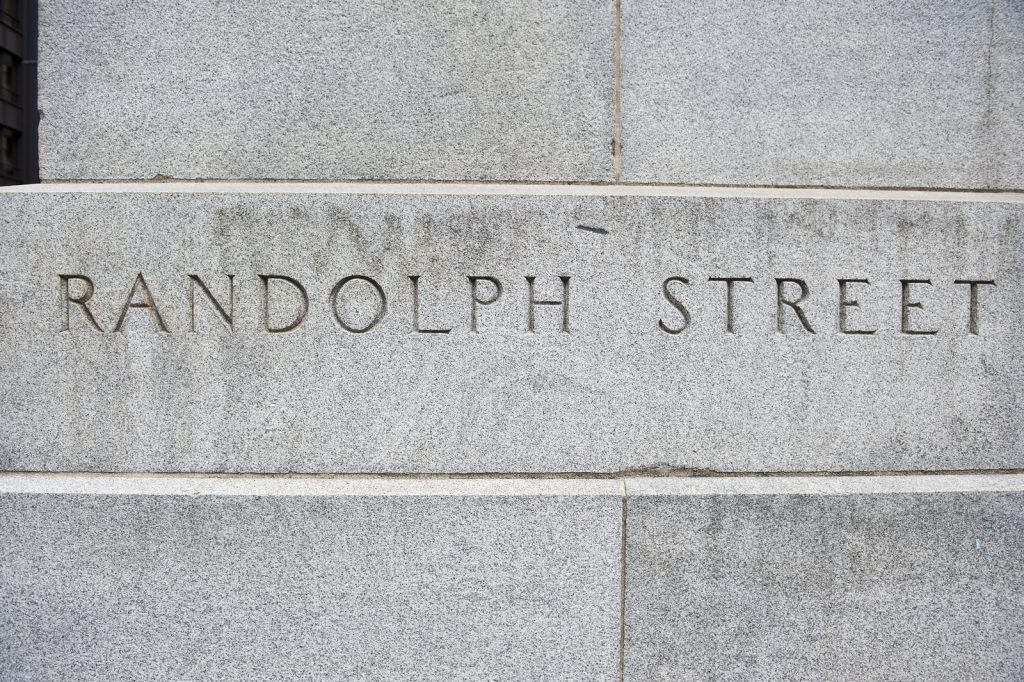 Name of Randolph Street carved on a concrete stone wall at Randolph street for people's convenience in Chicago, Illinois. The color of the wall in the picture is white.