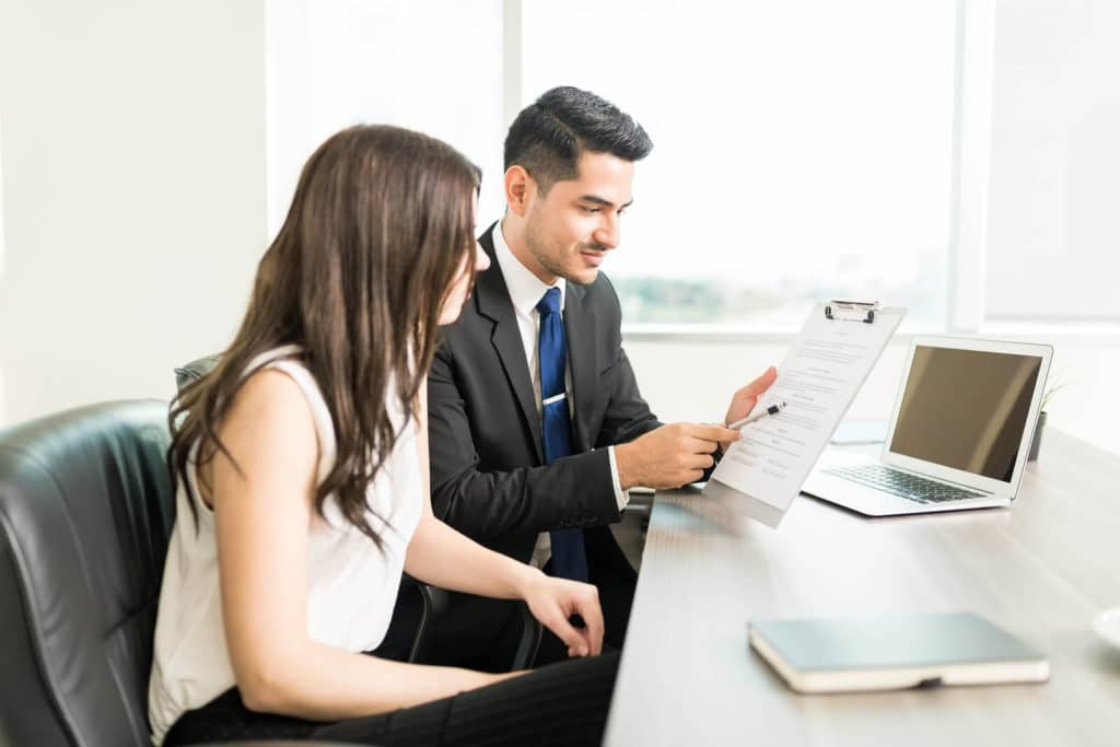 attorney reviewing legal documents with a client