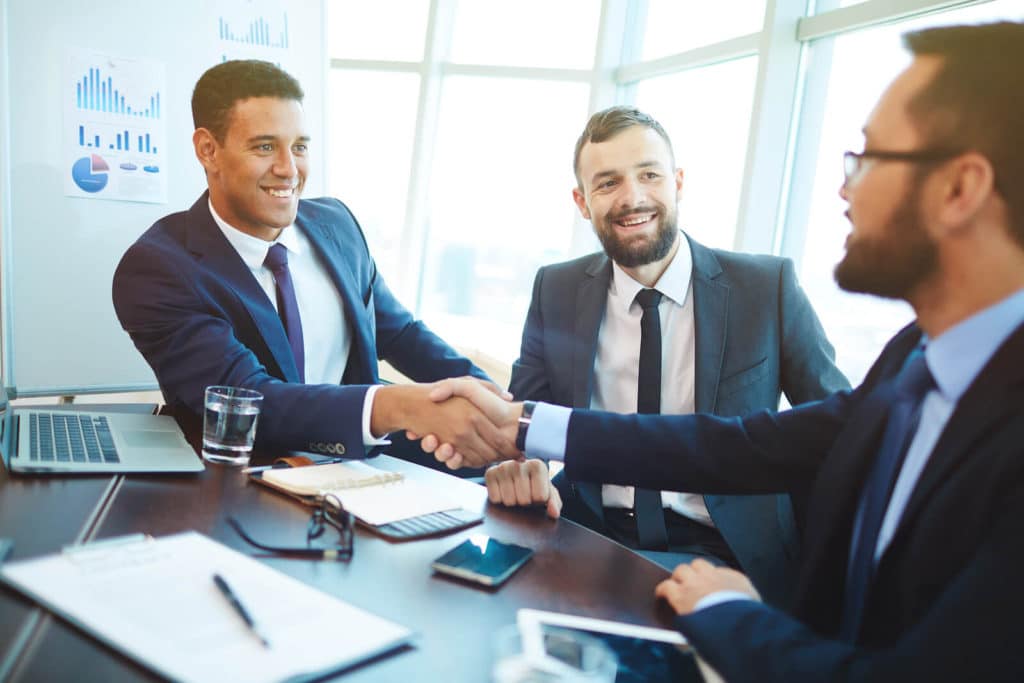 mortgage officers shaking hands with a client