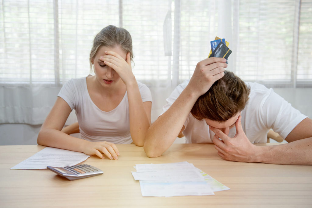 couple with a bill and credit cards