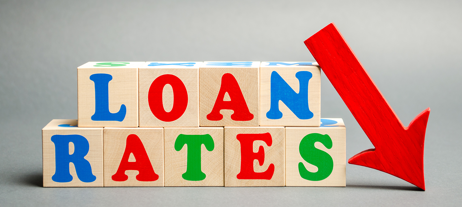 Wooden Blocks With The Word Loan Rates And Arrow Down. 